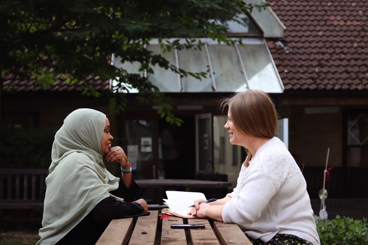 Two women sat on bench